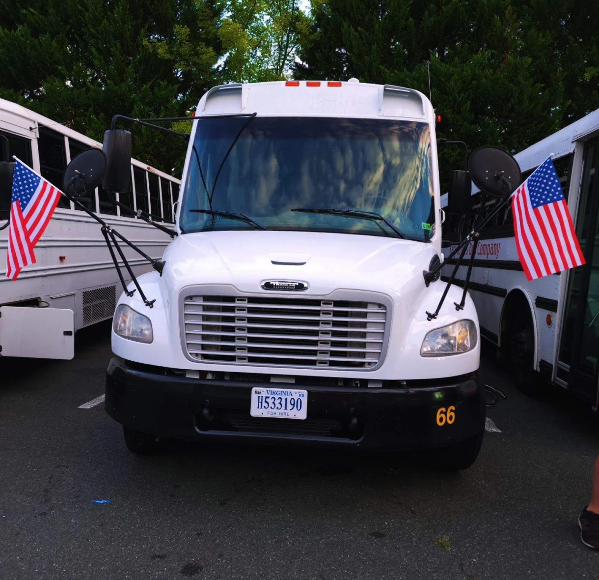 White bus with American flags displayed