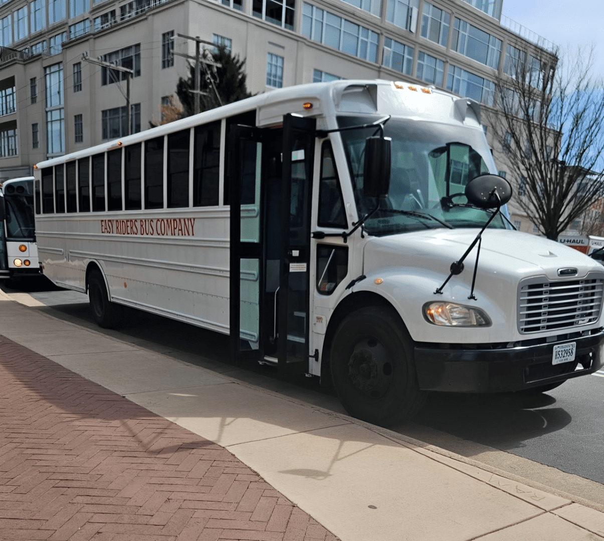 White bus parked on city street