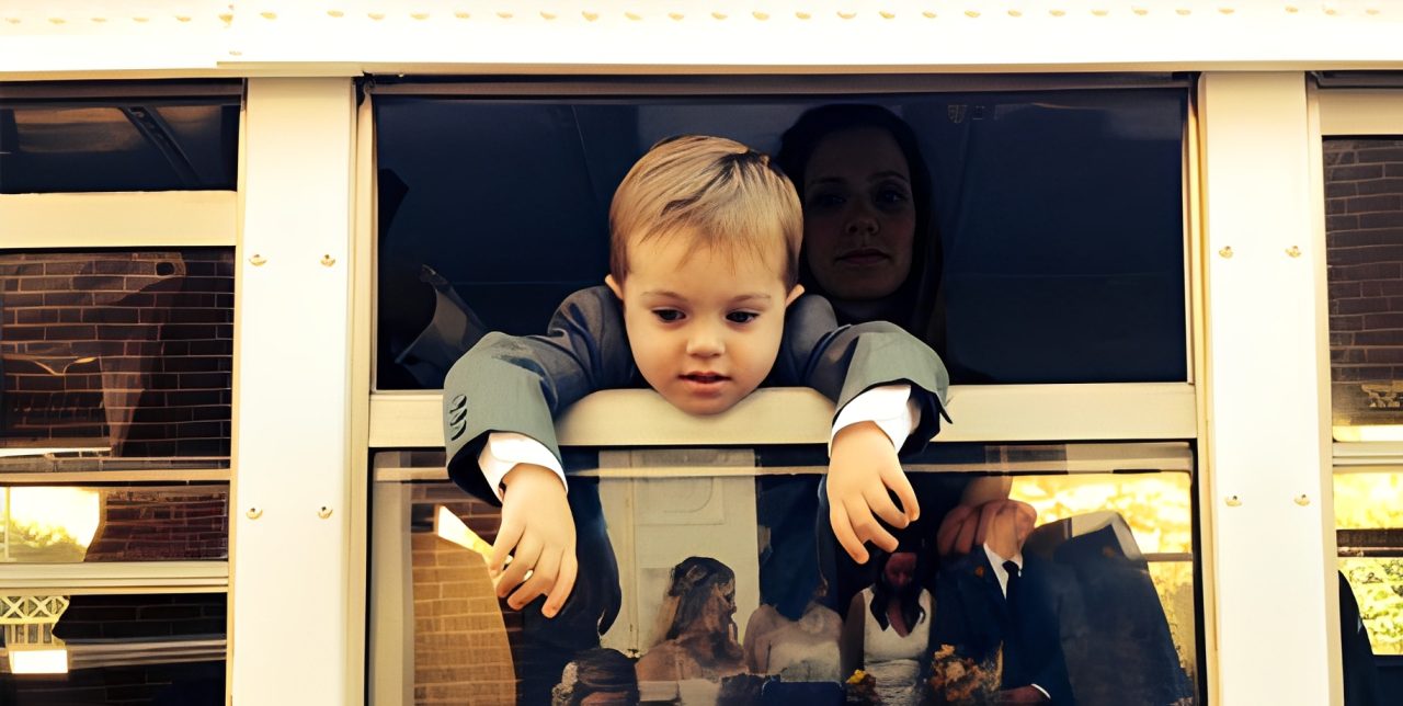 Child leaning out bus window